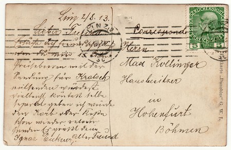 LINZ, AUSTRIA-HUNGRAY - AUGUST 8, 1913: Back of a vintage photo - used postcard. Rich stain and paper details. Can be used as background.  Image contains handwriting.のeditorial素材
