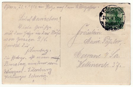 GERMANY - APRIL 23, 1916: Back of a vintage photo - used postcard. Rich stain and paper details. Can be used as background. Image contains handwriting.のeditorial素材