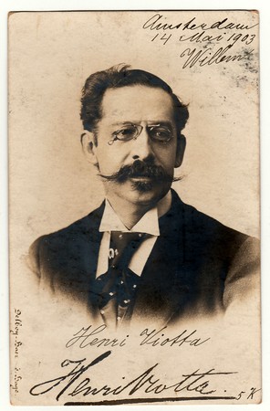 AMSTERDAM, THE NETHERLANDS - MAY 14, 1903: Vinatge photo shows man wears glasses and moustache. Antique black & white photography. Image contains handwriting.のeditorial素材