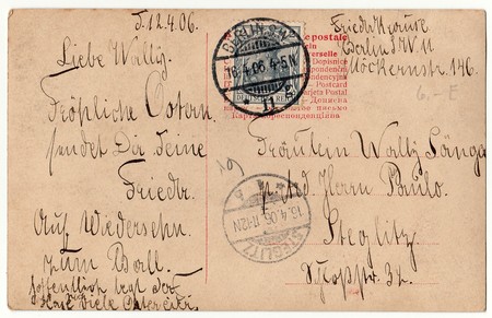 BERLIN, GERMANY - APRIL 12, 1906: Back of a vintage photo - used postcard. Rich stain and paper details. Can be used as background. Image contains handwriting.のeditorial素材