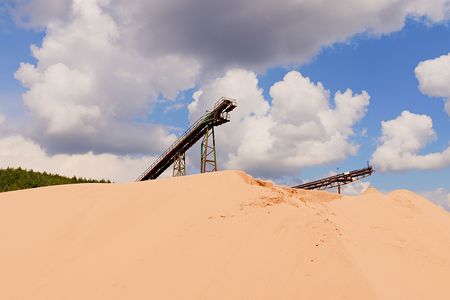 Conveyor belts and sand heaps. Construction industry. Sand quarry. Horizontal  photo.の写真素材