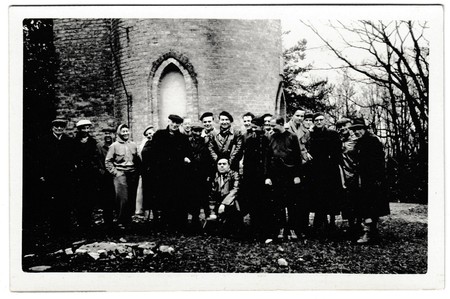 BEROUN, THE CZECHOSLOVAK SOCIALIST REPUBLIC - CIRCA 1960s: Retro photo shows a group of people poses...