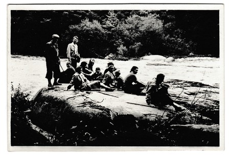 THE CZECHOSLOVAK SOCIALIST REPUBLIC -  JULY 4, 1954: Retro photo shows tourists have a rest on the bank of the river. Black & white vintage photography.のeditorial素材