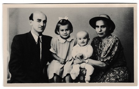 THE CZECHOSLOVAK SOCIALIST REPUBLIC - SEPTEMBER 10, 1947: Retro photo shows Russia family (father, mother and two daughters). Vintage black & white photography.のeditorial素材