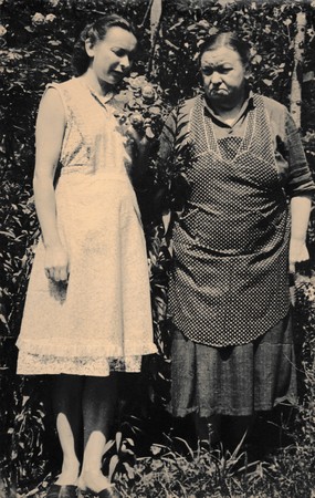 THE CZECHOSLOVAK SOCIALIST REPUBLIC - CIRCA 1960s: Retro photo shows two women stand in the garden. Black & white vintage photographyのeditorial素材