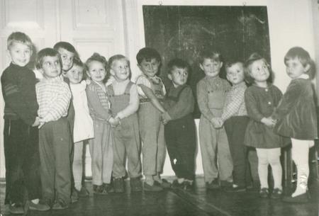 THE CZECHOSLOVAK SOCIALIST REPUBLIC - CIRCA 1960s: Retro photo shows small pupils in the classroom. Blackboard on the background.  Vintage black & white photography.のeditorial素材