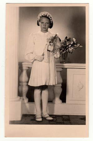 HODONIN, THE CZECHOSLOVAK REPUBLIC, CIRCA 1930: Vintage photo of a young girl -  her first holy communion, circa 1930.のeditorial素材