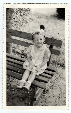 THE CZECHOSLOVAK REPUBLIC, CIRCA 1943: Vintage photo shows a small girl sits on a bench, circa 1943.のeditorial素材