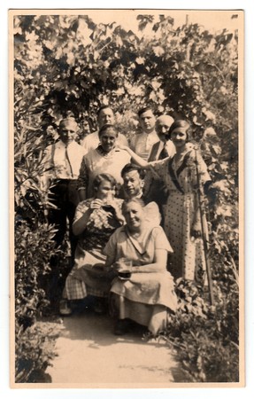 THE CZECHOSLOVAK REPUBLIC, CIRCA 1930: Vintage photo shows women and men in the back yard with grapes, circa 1930.のeditorial素材
