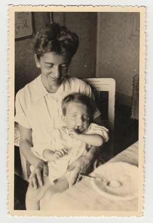 THE CZECHOSLOVAK REPUBLIC, CIRCA 1941: A small boy with mother during the meal, circa 1941.のeditorial素材