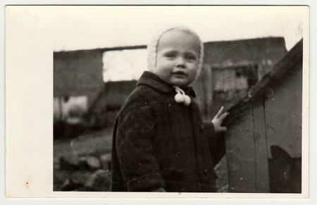 THE CZECHOSLOVAK REPUBLIC, CIRCA 1942: Vintage photo shows a small girl and kannel (doghouse), circa...