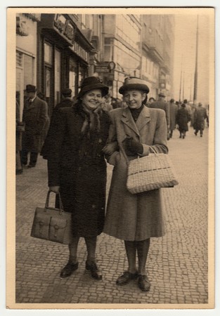 PRAGUE, THE CZECHOSLOVAK REPUBLIC - NOVEMBER, 1947: Vintage photo shows women go along the street.のeditorial素材