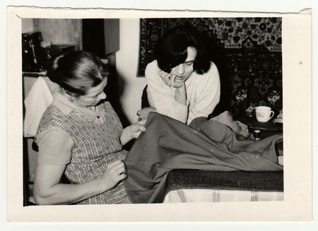 USSR - CIRCA 1970s: Vintage photo shows women prepare to sew a dress.のeditorial素材