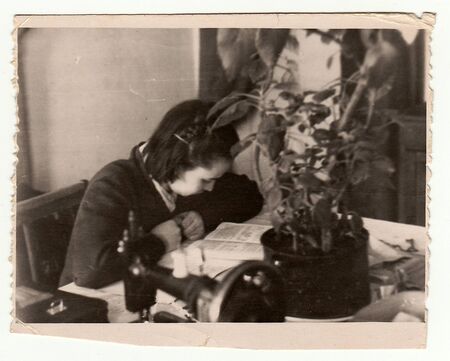 USSR - CIRCA 1970s: Vintage photo shows girl reads the book.のeditorial素材