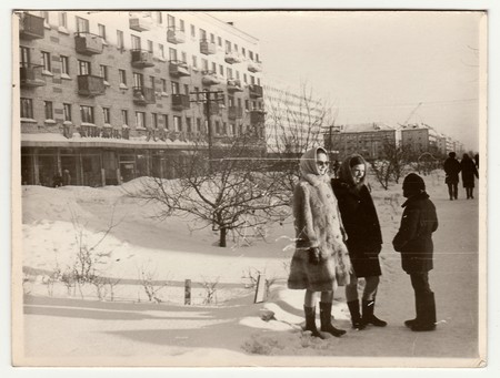 USSR - CIRCA 1980s: Vintage photo shows  girls and boy talk on street in winter.のeditorial素材