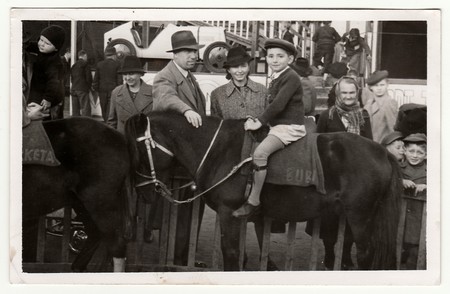 THE CZECHOSLOVAK SOCIALIST REPUBLIC - CIRCA 1950s: Vintage photo shows family in amusement park. A...