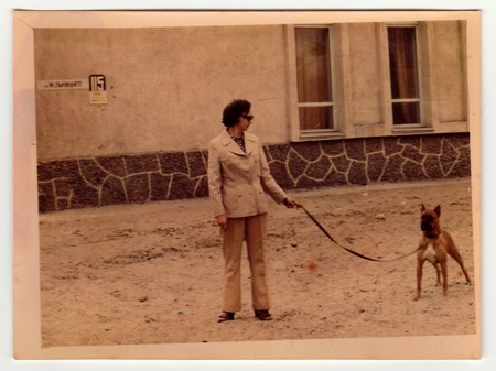 USSR - CIRCA 1970s: Vintage photo shows woman walks the dog.のeditorial素材