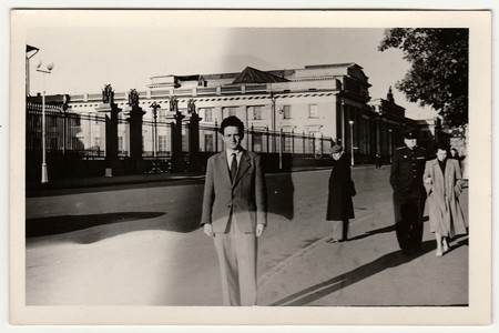 USSR - FEBRUARY 29, 1952: Vintage photo shows a young man poses on the street. Black & white retro photo.のeditorial素材