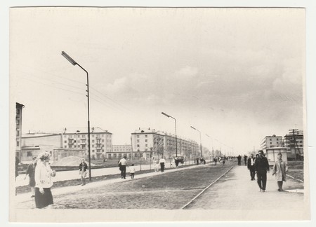 USSR - CIRCA 1980s: Vintage photo shows people walk along the boulevard. Blocks of flats on background.のeditorial素材
