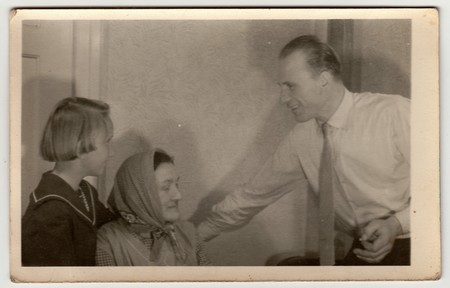 THE CZECHOSLOVAK SOCIALIST REPUBLIC - CIRCA 1950s: Vintage photo shows father, daughter and grandmother at home.のeditorial素材