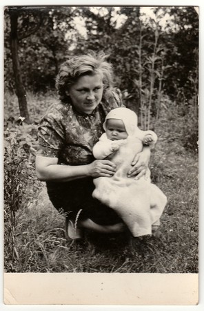 THE CZECHOSLOVAK SOCIALIST REPUBLIC - 1960s: Vintage photo shows young woman cradles baby.のeditorial素材