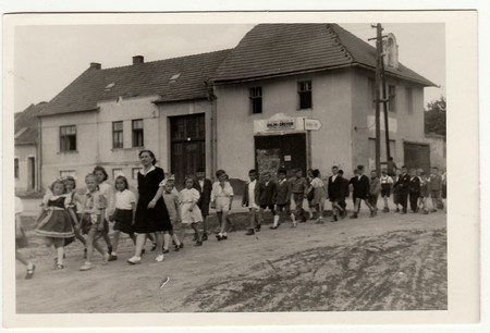 THE CZECHOSLOVAK SOCIALIST REPUBLIC - CIRCA 1940s: Vintage photo shows female teacher with her pupils go for a walk.のeditorial素材