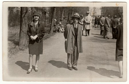 PREROV, THE CZECHOSLOVAK REPUBLIC - APRIL 26, 1928: Vintage photo shows young man and woman pose in the city park.のeditorial素材