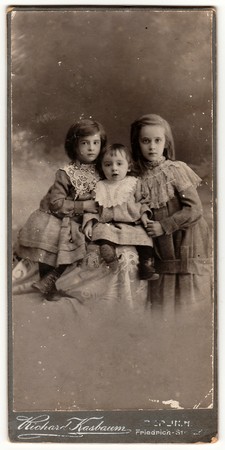 BERLIN, GERMANY- CIRCA 1905: A vintage cabinet card shows cute children (girls). Antique black & white photo.のeditorial素材