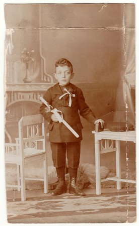 HODONIN,  AUSTRIA-HUNGARY - CIRCA 1910s:  A vintage photo shows young boy - the first holy communion. Antique black & white photo with sepia tint.のeditorial素材