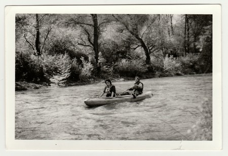 THE CZECHOSLOVAK SOCIALIST REPUBLIC - CIRCA 1980s: Vintage photo shows young canoeists on the river.のeditorial素材