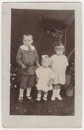GERMANY - AUGUST, 1929: Vintage photo shows children (siblings) pose outdoors.  Black & white antique photo.のeditorial素材