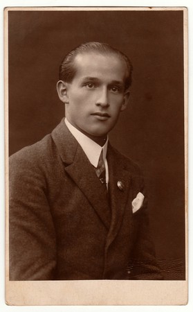 LIBEREC (REICHENBERG), THE CZECHOSLOVAK REPUBLIC - CIRCA 1920s: Vintage photo shows young man wears jacket.  Antique black & white studio portrait.のeditorial素材