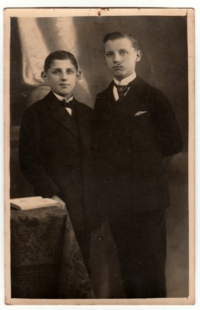 THE CZECHOSLOVAK REPUBLIC - CIRCA 1920s: Vintage photo shows boys wear jackets with handkerchief in the pocket.  Antique black & white studio portrait. On top of image is imprint of drawing pin.のeditorial素材