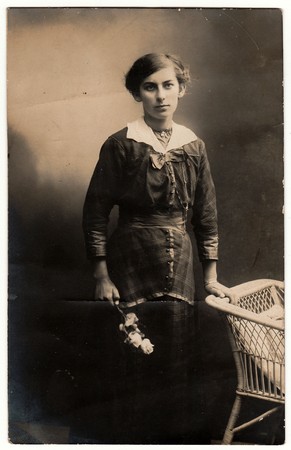SOLINGEN, GERMANY - CIRCA 1920s: Vintage photo shows woman holds roses. Black & white photo with...