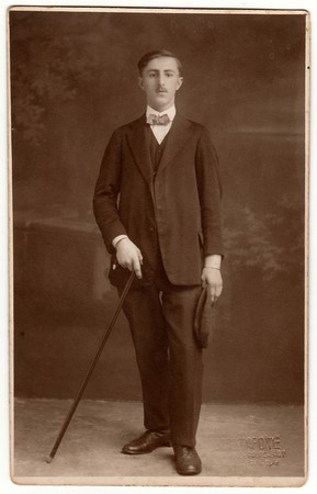 THE CZECHOSLOVAK REPUBLIC - CIRCA 1930s: Vintage photo shows a young man holds walking stick. Black...