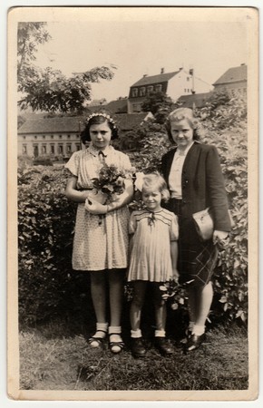 THE CZECHOSLOVAK  REPUBLIC - 1946: Vintage photo shows girls with mother after confirmation ceremony. Black & white antique photography.のeditorial素材
