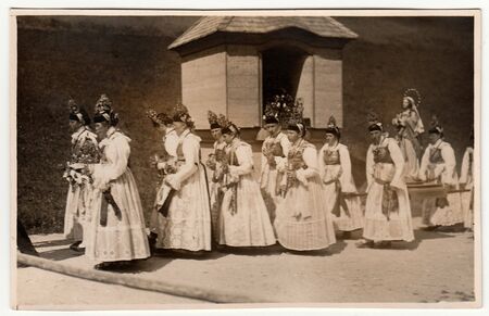 GERMANY - CIRCA 1930s: Vintage photo shows young women during religion procession. Women wear folk costums. Black & white antique photography.のeditorial素材