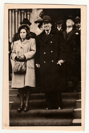 PRAGUE, THE CZECHOSLOVAK REPUBLIC - 1946: Vintage photo shows newlyweds stand on stairs after wedding ceremony. Black & white antique photography.のeditorial素材