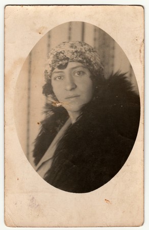 THE CZECHOSLOVAK REPUBLIC - CIRCA 1940s: Vintage photo shows an elegant woman wears fur scarf. Antique black & white photo is oval shaped.のeditorial素材