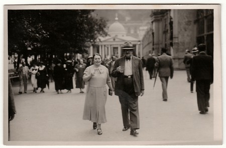MARIANSKE LAZNE, THE CZECHOSLOVAK REPUBLIC - JUNE, 1936: Vintage photo shows a mature couple goes for a walk in the spa resort. Black & white antique photography.のeditorial素材