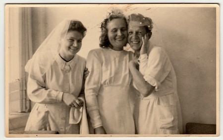 THE CZECHOSLOVAK  REPUBLIC - CIRCA 1930s: Vintage photo shows nurses, one of them prepares to wedding ceremony . Black & white antique photography.のeditorial素材