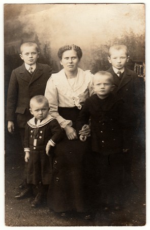 GERMANY - CIRCA 1920s: Vintage photo shows mother and her four sons. One of them wears sailor costum. Black & white antique photography.のeditorial素材
