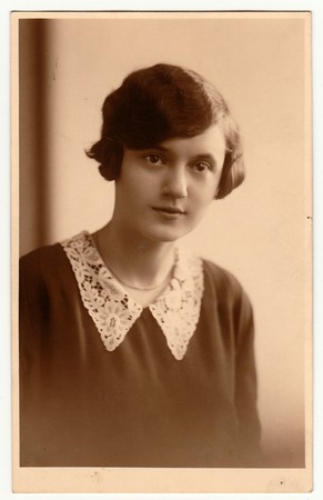 PRAHA (PRAGUE), THE CZECHOSLOVAK REPUBLIC - CIRCA 1930s: The vintage photo shows portrait of young woman. The studio photography with sepia effect was taken in early 1930s.のeditorial素材