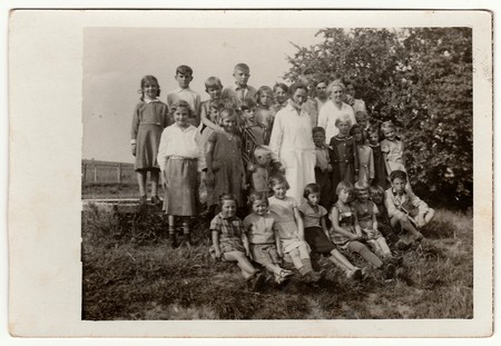 GERMANY - 1934: Vintage photo shows group of children with female doctors.