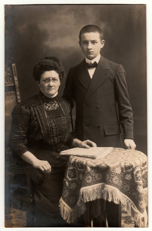 GERMANY - CIRCA 1930s: Vintage photo shows mother and her son. Black & white studio photography.