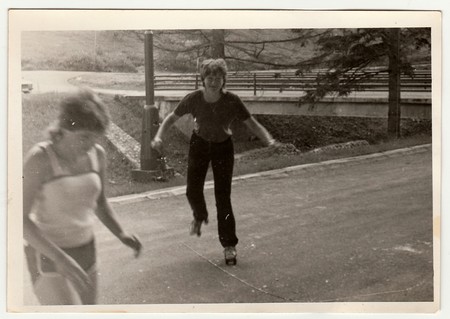 THE CZECHOSLOVAK SOCIALIST REPUBLIC - CIRCA 1970s: Retro photo shows girl who rides on roller skates . Black & white vintage photography.のeditorial素材