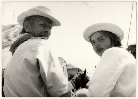 THE CZECHOSLOVAK SOCIALIST REPUBLIC - CIRCA 1970s: Retro photo shows man and boy ride horse cart. Black & white vintage photography.のeditorial素材