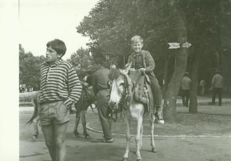 USSR - CIRCA 1970s: Retro photo shows boy rides on donkey in the park. Vintage black & white photography.のeditorial素材