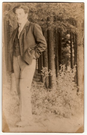THE CZECHOSLOVAK REPUBLIC - CIRCA 1930s: Vintage photo shows a young man in the forest. Retro black...