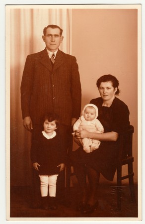 RICANY, THE CZECHOSLOVAK REPUBLIC - 1930: Vintage photo shows family in the photography studio....